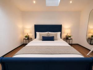 a bedroom with a large bed with two lamps at The Regent in Warrington