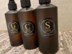 three bottles of shampoo sitting on a table at The Regent in Warrington