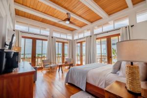 a bedroom with a bed and a table with a television at Aruna Resort & Villas in San Pedro +192 photos