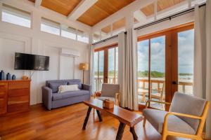 a living room with a couch and a table at Aruna Resort & Villas in San Pedro