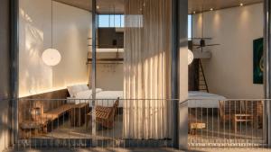 a room with a balcony with a bedroom and a bed at Rucha Beachfront Retreat in Ấp An Lộc A