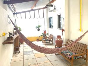 a porch with a hammock in a room at Casa Expocrato in Crato