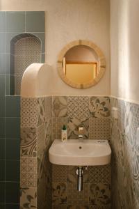 a bathroom with a sink and a mirror at Yara Lodge in Tamraght Ou Fella