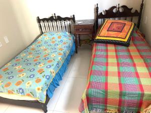 two beds sitting next to each other in a room at Casa Expocrato in Crato