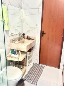 a bathroom with a sink and a toilet and a mirror at Casa Expocrato in Crato