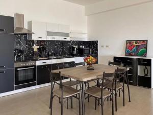 a kitchen with a wooden table and chairs at Spring Garden Ocean View in Montego Bay