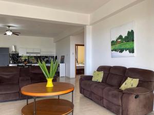 a living room with a couch and a table at Spring Garden Ocean View in Montego Bay