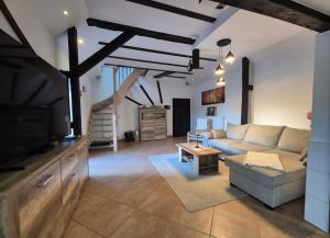 a living room with a couch and a tv at Spreeperle in Lübbenau