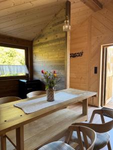 a wooden cabin with a table and chairs at Apartament pod Świerkami in Witów +26 photos