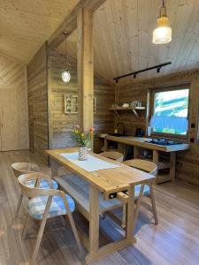 a dining room with a wooden table and chairs at Apartament pod Świerkami in Witów