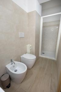 a bathroom with a white toilet and a sink at Ciccio's House in Giardini Naxos +14 photos