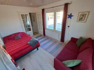 a living room with a bed and a couch at Guesthouse Northern Star in Muonio +38 photos