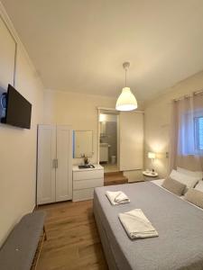 a bedroom with a bed and a television in it at Spiros apartment - Loggos, Paxos in Longós