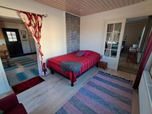 a bedroom with a bed with a red blanket at Guesthouse Northern Star in Muonio