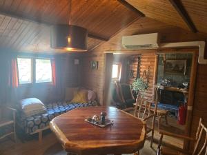 a living room with a wooden table and a couch at Tranan' in Karlsborg