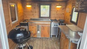 a kitchen with a stove and a pan on a counter at Tranan' in Karlsborg +27 photos