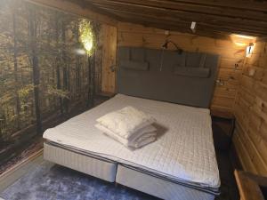 a bed in a small room with a window at Tranan' in Karlsborg