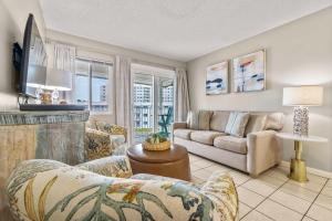 a living room with a couch and a fireplace at Plantation East #2310 in Gulf Highlands