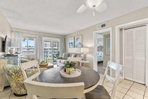 a dining room and living room with a table and chairs at Plantation East #2310 in Gulf Highlands +38 photos