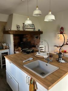 a kitchen with a sink and a fireplace at matana b&b in Carmignano +45 photos