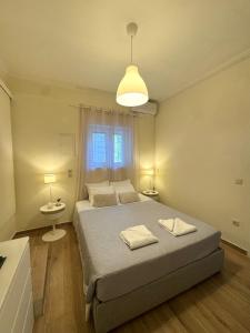 a bedroom with a bed with two towels on it at Spiros apartment - Loggos, Paxos in Longós