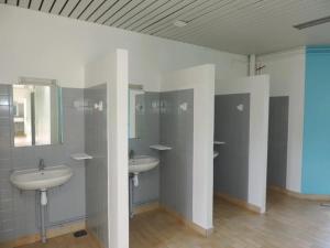 a bathroom with two sinks and two mirrors at Camping 3 étoiles - Piscine - ccbgaci in Illiers +11 photos