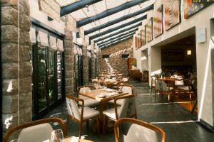 a restaurant with tables and chairs in a room at Sanctuary Lodge, A Belmond Hotel, Machu Picchu in Machu Picchu