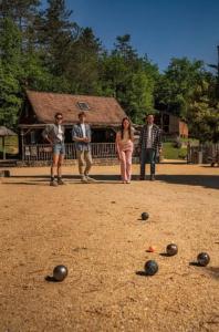 a group of people standing around balls on the ground at Camping 3 étoiles - Piscine - ccbfh0d in Saint-Amand-de-Coly