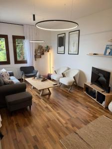 a living room with a couch and a tv at M Villa Pelion in Tsagarada