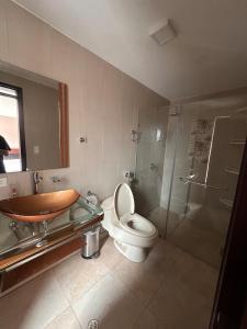 a bathroom with a toilet and a glass shower at Kasa Akiro in Juivi +11 photos