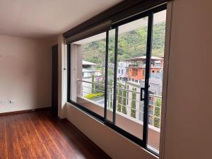 a room with large windows with a view of a building at Kasa Akiro in Juivi