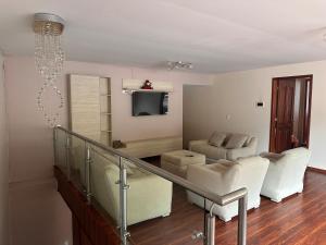 a living room with a couch and a television at Kasa Akiro in Juivi
