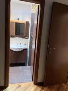 a bathroom with a sink and a mirror and a toilet at M Villa Pelion in Tsagarada +24 photos