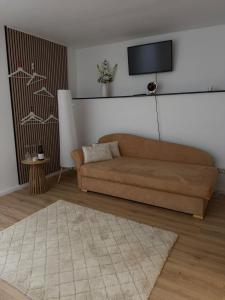a living room with a couch and a flat screen tv at Enjoy-Zimmer in Altenahr +5 photos