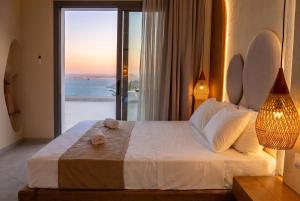 a bedroom with a bed with a view of the ocean at Anemolia Villas in Karpathos +31 photos