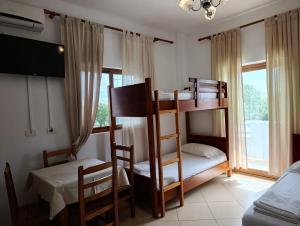 a room with two bunk beds and a window at Aparthotel Fitimi in Borsh