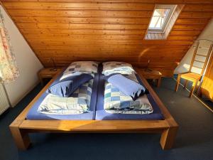 a bed with two pillows on it in a room at Ferienhaus Winkelwerk in Goslar