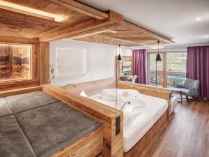 a bedroom with a large bed in a room at Hotel Magdalena im Zillertal - Urlaub mit Hund in Ried im Zillertal +93 photos