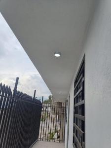 a hallway with a gate and a fence at Huset södra Quito in Quito +5 photos