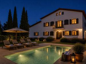 a house with a swimming pool in front of a building at Le Mirage in Cambrils