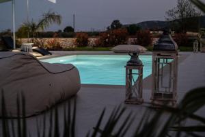 two lanterns sitting next to a swimming pool at Villa Arancia in Argos