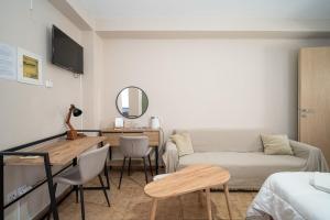 a living room with a couch and a table at Nisaki City Vibes in Chios
