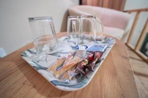 a plate with two glasses on top of a table at Nisaki City Vibes in Chios