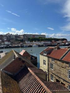 a view of a city with a river and buildings at Annie Place in Whitby