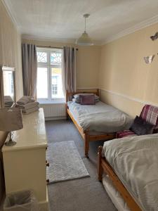 a bedroom with two beds and a window at Annie Place in Whitby