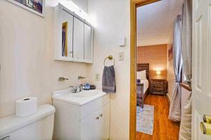 a white bathroom with a sink and a toilet at Lake Front Firepit Dock Game Room Pets OK in Locust Lakes Village +50 photos