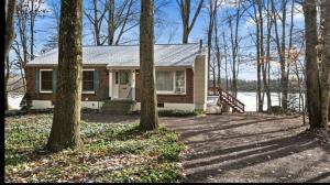 a small house in the woods with trees at Lake Front Firepit Dock Game Room Pets OK in Locust Lakes Village