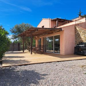 a pavilion with a table and chairs on a wooden deck at Mas del Sola in Castelnou