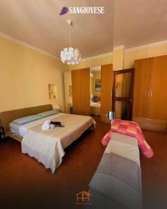 a bedroom with two beds and a chandelier at La Cameranense by Homes in Ancona in Camerano