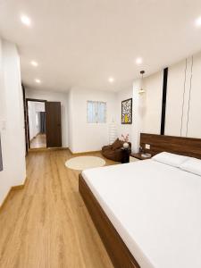 a bedroom with a bed and a living room at Linh's Home in Danang